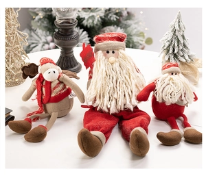 Detail of Christmas plush Santa and reindeer dolls with cozy knitted and velvet textures