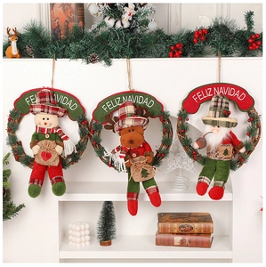 Detailed view of three hanging Christmas wreaths with snowman, reindeer and Santa figures