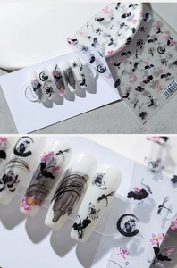 Macro detail of ink lotus nail stickers with dragonfly designs on white nail tips