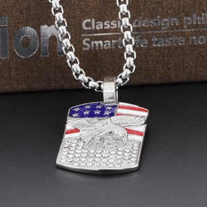 Macro shot of stainless steel eagle shield pendant with USA flag and crystal accents