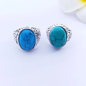 Detailed macro view of vintage silver rings featuring engraved patterns and turquoise stones