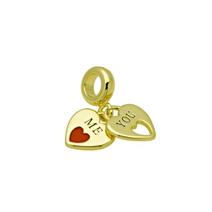 Detailed view of gold double heart charm featuring red enamel ME and hollow YOU engraving