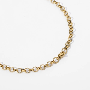 Detail of golden stainless steel cable chain necklace featuring a secure lobster clasp
