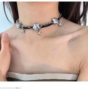 Y2K style choker featuring black cord with silver star charms and sparkling zircon stones