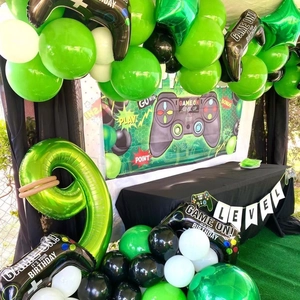 Gamer birthday party set with green number 9 balloon, gamepad foil and level up banner