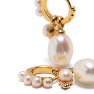 Gold hoop earrings with round pearls and a large oval pearl pendant on white background