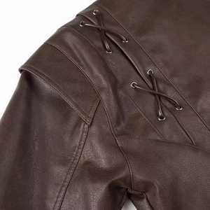 Detail of dark brown leather jacket shoulder with lace-up eyelet design