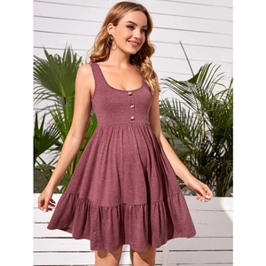 Detail of ruffle hem and button front on a mauve maternity A-line tank dress
