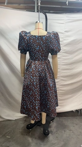Detail of square neckline and puff sleeves on vintage polka dot satin dress