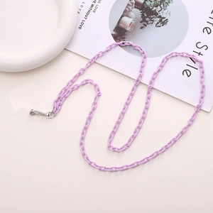 Detail of purple acrylic cross-body phone chain with metal clip on white background