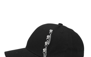 Detail of black cotton baseball cap featuring silver metal chains and gothic style studs
