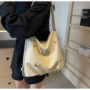 Detail of cream PU leather tote bag with five 3D golden metal butterfly embellishments
