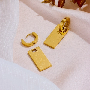 Detail view of 18k gold plated stainless steel square hoop earrings with clover motif