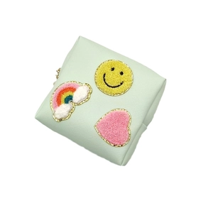 Portable mint green fabric pouch with rainbow, smiley face, and heart chenille patches