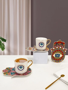 Close-up of ceramic Turkish coffee cups with Hamsa Hand and Evil Eye patterns