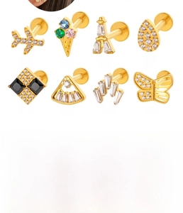 Macro detail of titanium cartilage studs featuring zircon inlays and diverse charm shapes