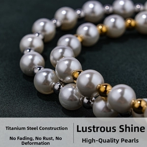 Detail of high-luster white shell pearls and durable titanium steel gold-toned spacers