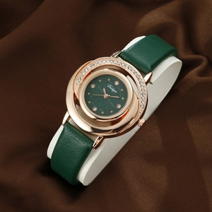 Detail of luxury green leather watch with rose gold rhinestone case on silk fabric