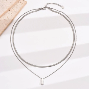 Detail view of double layer titanium steel necklace with drop pendant and adjustable chain