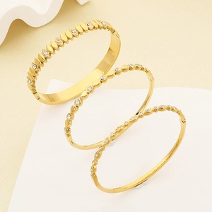 Detail of three-piece 18K gold plated stainless steel bracelets with white zircon inlay