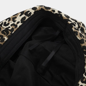 Detail view of leopard print beret featuring black lining and adjustable drawstring cord