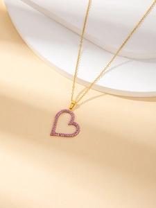 Golden heart necklace featuring pinkish purple crystals on a minimalist hollow pendant