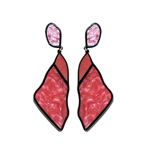 Red and pink geometric irregular acrylic drop earrings with marble texture on white background