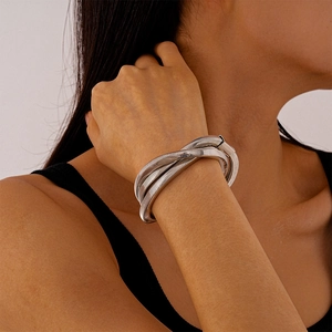 Detailed view of silver multi-layer snake bone textured metal cuff bracelet on wrist