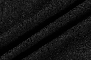 Gros plan sur un tissu en dentelle noire avec des motifs floraux et géométriques