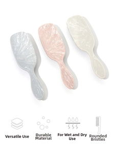 Detail view of marble pattern cushion brushes with soft rounded bristles for scalp care