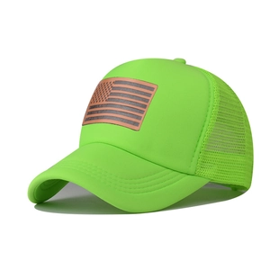 Detail of neon green mesh trucker hat with American flag leather patch on the front