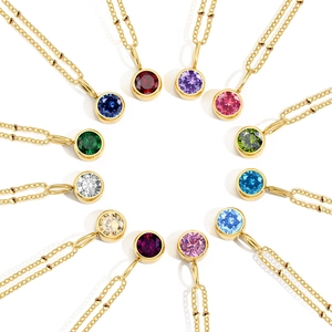 Birthstone necklace collection with 12 colorful gems and gold beaded chain on white background
