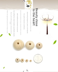 Various sizes of unfinished natural wood beads for DIY crafts compared with a coin