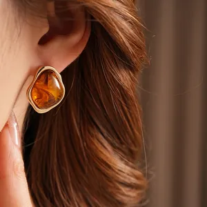 Vintage geometric amber resin earrings with polished gold edges in a modern pebble shape