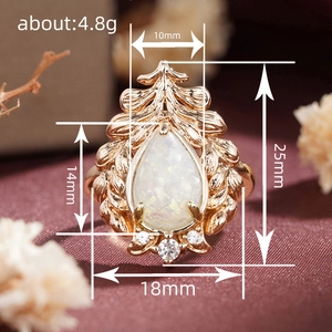 Baroque rose gold leaf ring with pear-cut opal and sparkling white crystals
