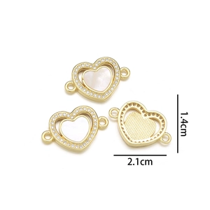 Detail of heart shell pendants with rhinestones measuring 1.4cm height and 2.1cm width