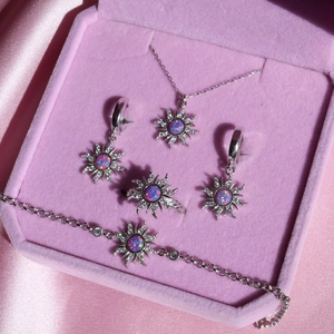 Silver sunburst jewelry set with opal center and zircon accents in pink velvet box
