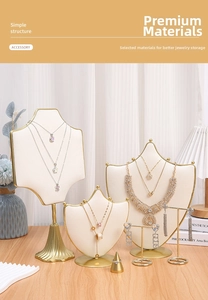 Detailed cream velvet jewelry display set with gold metal accents on a wooden table