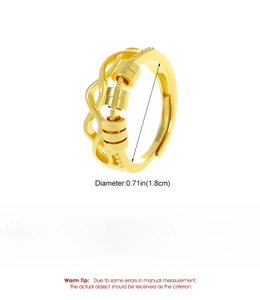Detail of golden copper ring with wave lines and three sliding beads for stress relief