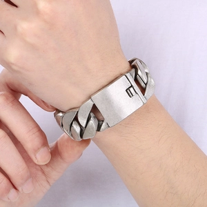 Macro shot of retro silver Cuban link bracelet with a wide chain design and buckle clasp