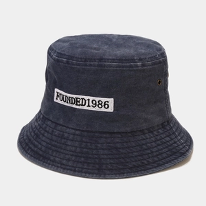 Detail of Founded 1986 embroidery on washed retro cotton bucket hat with metal eyelet