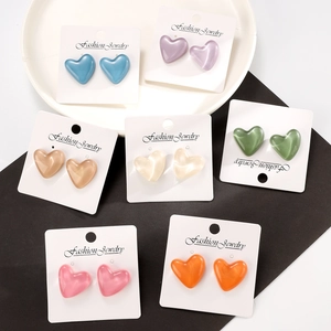 Colorful heart-shaped stud earrings set with polished resin finish in seven vibrant shades