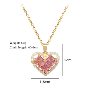 Detail view of heart necklace with pearls and pink gems showing dimensions and weight