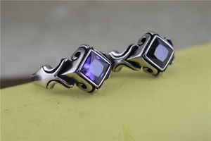 Detailed macro view of vintage gothic rings with square cut purple and black gemstones