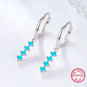 Detailed macro of 925 sterling silver drop earrings with four turquoise stones