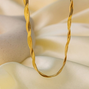 Detailed macro view of high-quality golden double-layered snake chain necklace on silk