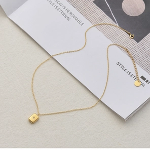 Detail of 18K gold-plated star pendant necklace with gemstone on magazine background