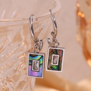 Macro detail of rectangle earring with abalone shell inlay and zircon on glass rim
