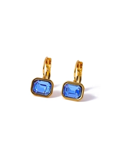 Detailed close-up of golden earrings with square-cut blue zircon stones for women