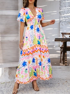 Detail of bohemian V-neck dress with colorful abstract print and ruffle hem on a model